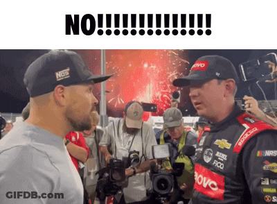 Man In Hat With Nos Talks To Another GIF