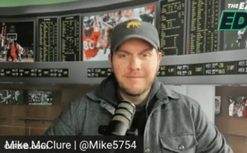 Man In Hat With Tiger Standing At Microphone GIF