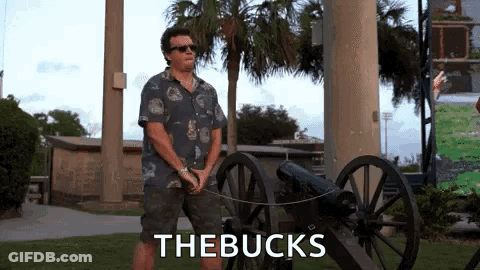 Man In Hawaiian Shirt Beside Cannon Saying The Bucks GIF