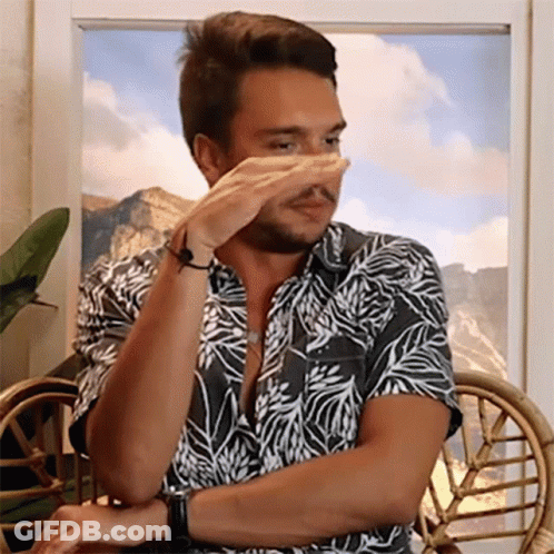 Man In Hawaiian Shirt Covering Nose GIF