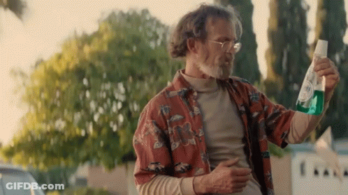Man In Hawaiian Shirt Holding Green Bottle GIF