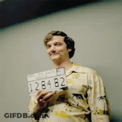 Man In Hawaiian Shirt Holding License Plate 128482 GIF