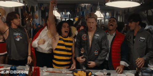 Man In Hawks Shirt Surrounded By People GIF