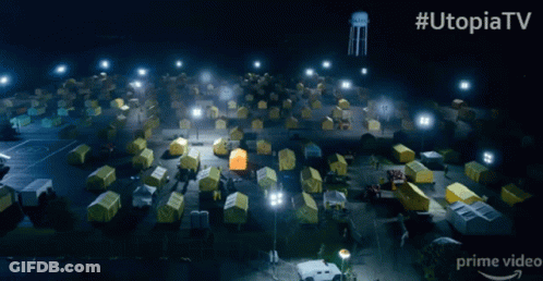 Man In Hazmat Suit Standing In Front Of Tents #UtopiaTV GIF