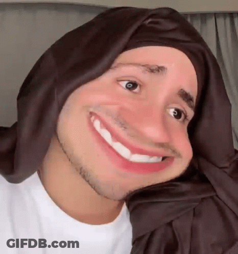 Man In Head Scarf Smiling And Making Face GIF