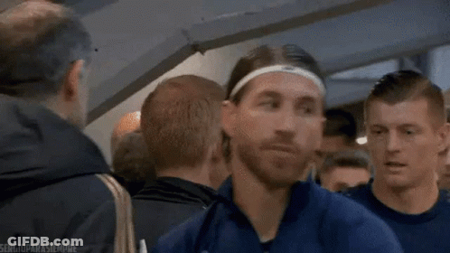 Man In Headband And Blue Jacket Standing In Crowd GIF
