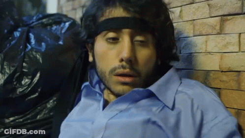 Man In Headband And Blue Shirt Laying Down GIF