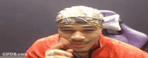 Man In Headband And Red Jacket With Purple Chair GIF