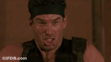 Man In Headband Funny Face In Dark Room GIF