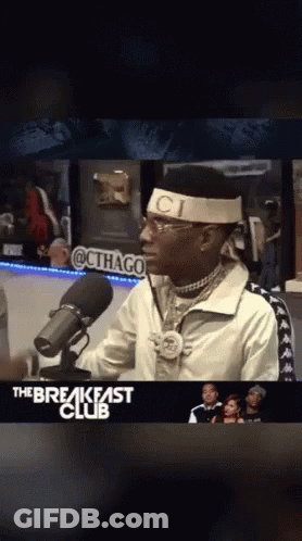 Man In Headband Saying Ci In Front Of Microphone GIF