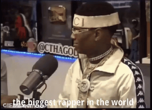Man In Headband With CI Letter At Microphone GIF