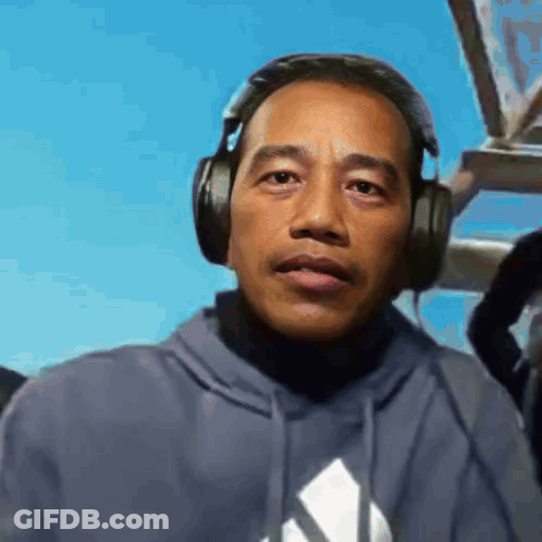 Man In Headphones And Adidas Hoodie GIF