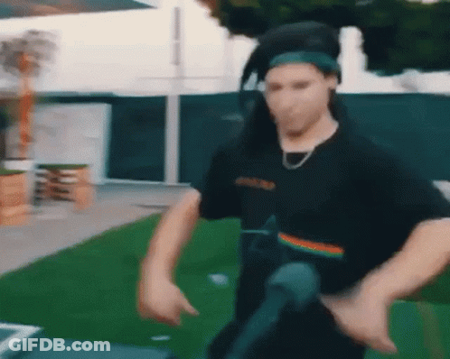 Man In Headphones And Bandana Dancing In Field GIF