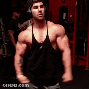 Man In Headphones And Black Tank Top In Gym GIF