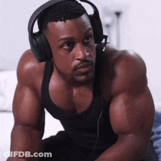 Man In Headphones And Black Tank Top Looking At Camera GIF