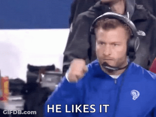 Man In Headphones And Blue Jacket Says He Likes It During Football Game GIF