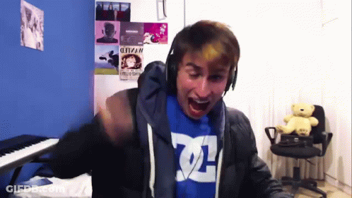 Man In Headphones And Blue Shirt Saying DC GIF