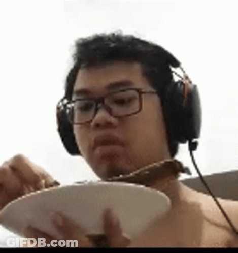 Man In Headphones And Glasses Eating From Bowl GIF