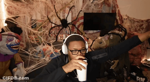 Man In Headphones And Glasses Holding Cup GIF