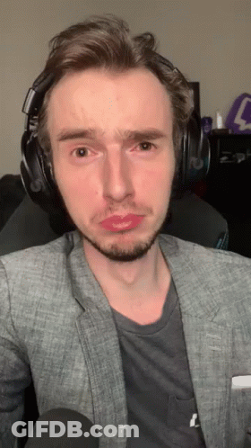 Man In Headphones And Gray Jacket Making A Face GIF