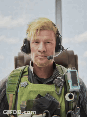 Man In Headphones And Green Vest With US Air Force Badge GIF