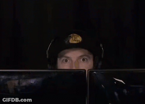 Man In Headphones And Hat At Two Monitors GIF