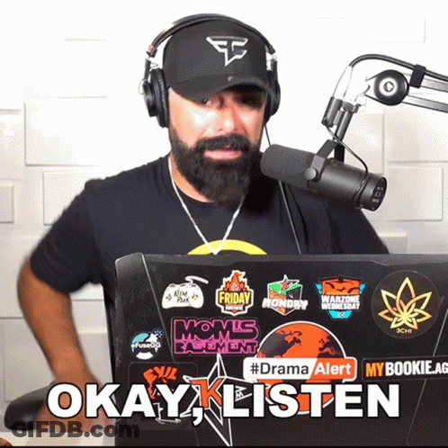 Man In Headphones And Hat In Front Of Laptop Says Okay Listen GIF