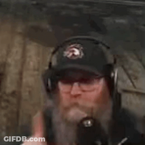 Man In Headphones And Hat Smoking Cigarette In Dark Room GIF