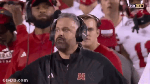 Man In Headphones And Jacket With Letter N Watching Football GIF