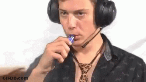 Man In Headphones And Leopard Tie Eating Lollipop GIF