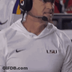 Man In Headphones And LSU Shirt Watching Football GIF