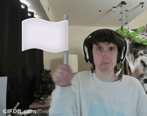 Man In Headphones And Miami Shirt Holding White Flag GIF