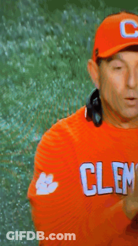 Man In Headphones And Orange Shirt Saying Cleveland GIF