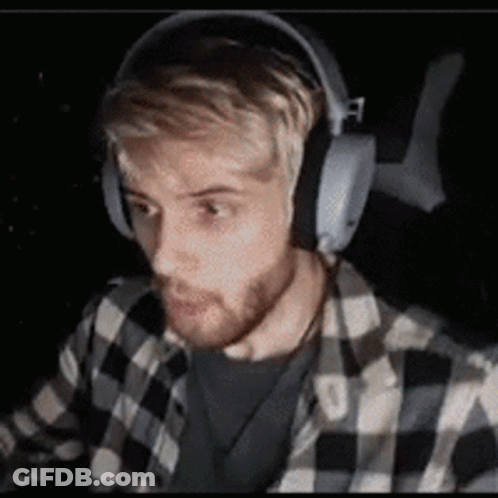 Man In Headphones And Plaid Shirt Sitting GIF