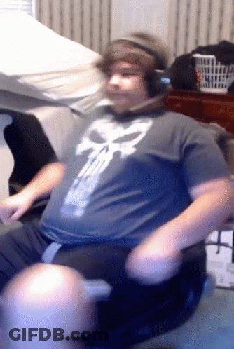 Man In Headphones And Punisher Shirt Sitting GIF