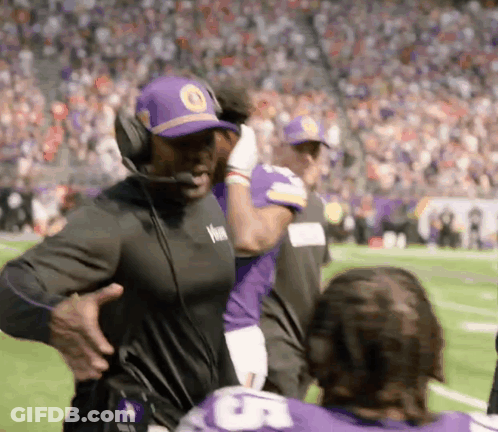 Man In Headphones And Purple Hat On Football Field GIF