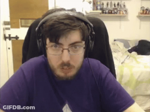 Man In Headphones And Purple Shirt Looking At Camera GIF