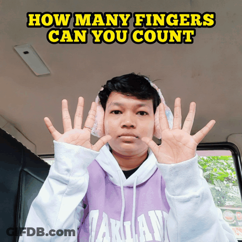 Man In Headphones And Purple Takuan Sweatshirt Holding Up Fingers GIF