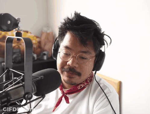 Man In Headphones And Red Bandana Talking Into Microphone GIF
