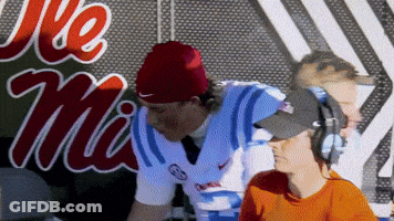 Man In Headphones And Red Beanie At Ole Miss Sign GIF