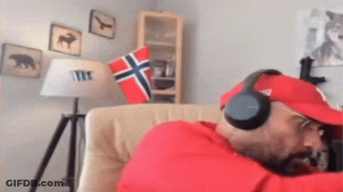 Man In Headphones And Red Hat Sitting In Chair GIF