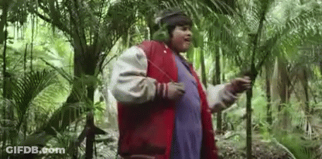 Man In Headphones And Red Jacket Standing In Woods GIF