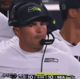 Man In Headphones And Seahawks Hat Watching Football GIF