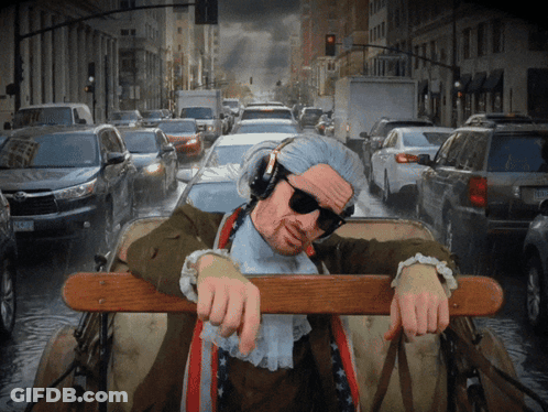 Man In Headphones And Sunglasses Leaning Over Railing In Car GIF