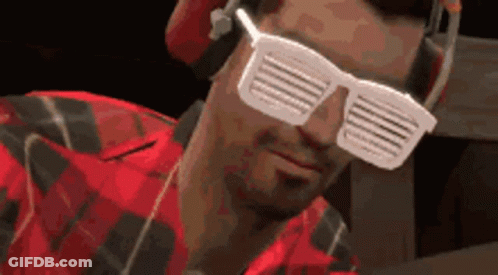 Man In Headphones And Sunglasses Looks At Camera GIF