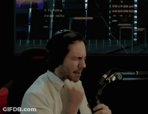 Man In Headphones And Tie Holding Fist Up GIF