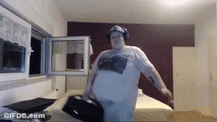 Man In Headphones And White Shirt Standing In Room GIF