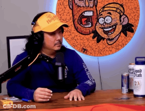 Man In Headphones And Yellow Hat With Liquid Death GIF