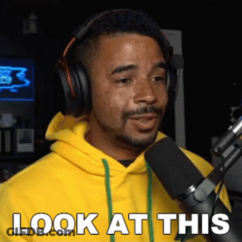 Man In Headphones And Yellow Hoodie Saying Look At This GIF
