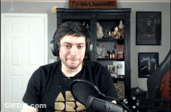 Man In Headphones At Microphone In Front Of Mr Llama Sign GIF